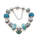 Bracelet with blue and silver charms on a white background