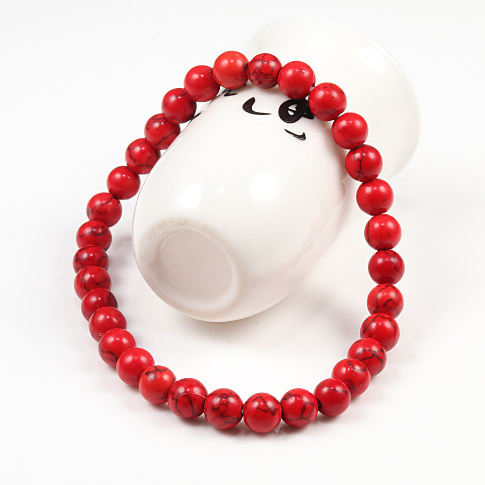Red beaded bracelet on a white background