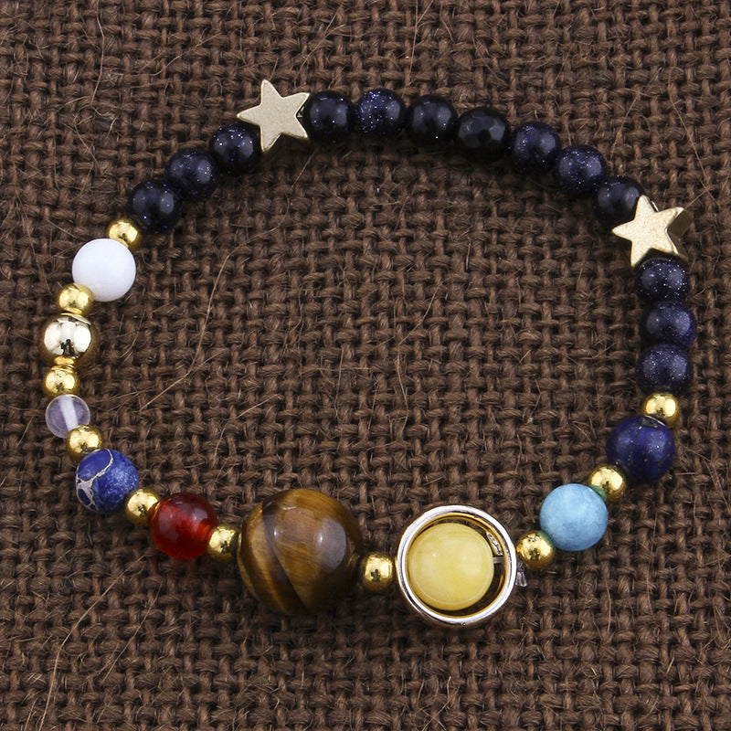Bracelet with star-shaped ends and various colored beads on a brown textured background