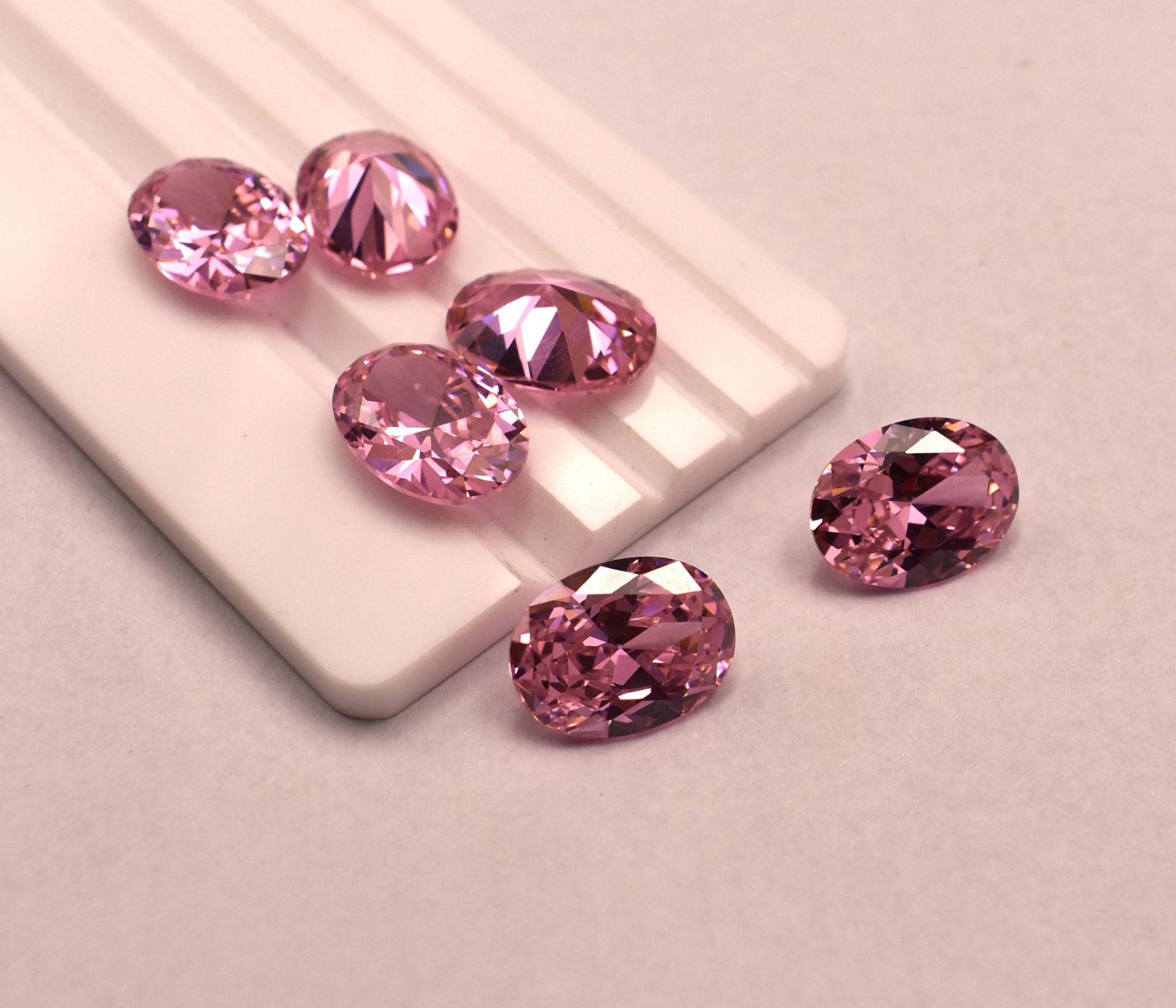 Pink gemstones on a light pink background