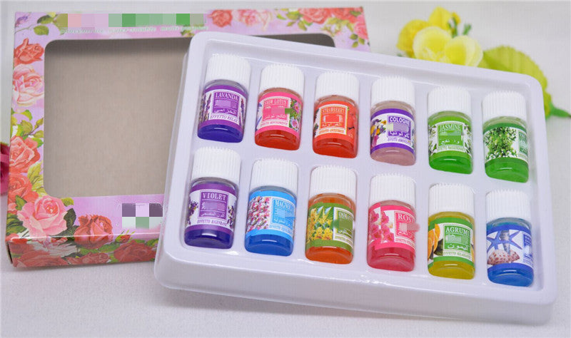 Set of small bottles with colorful labels in a decorative box