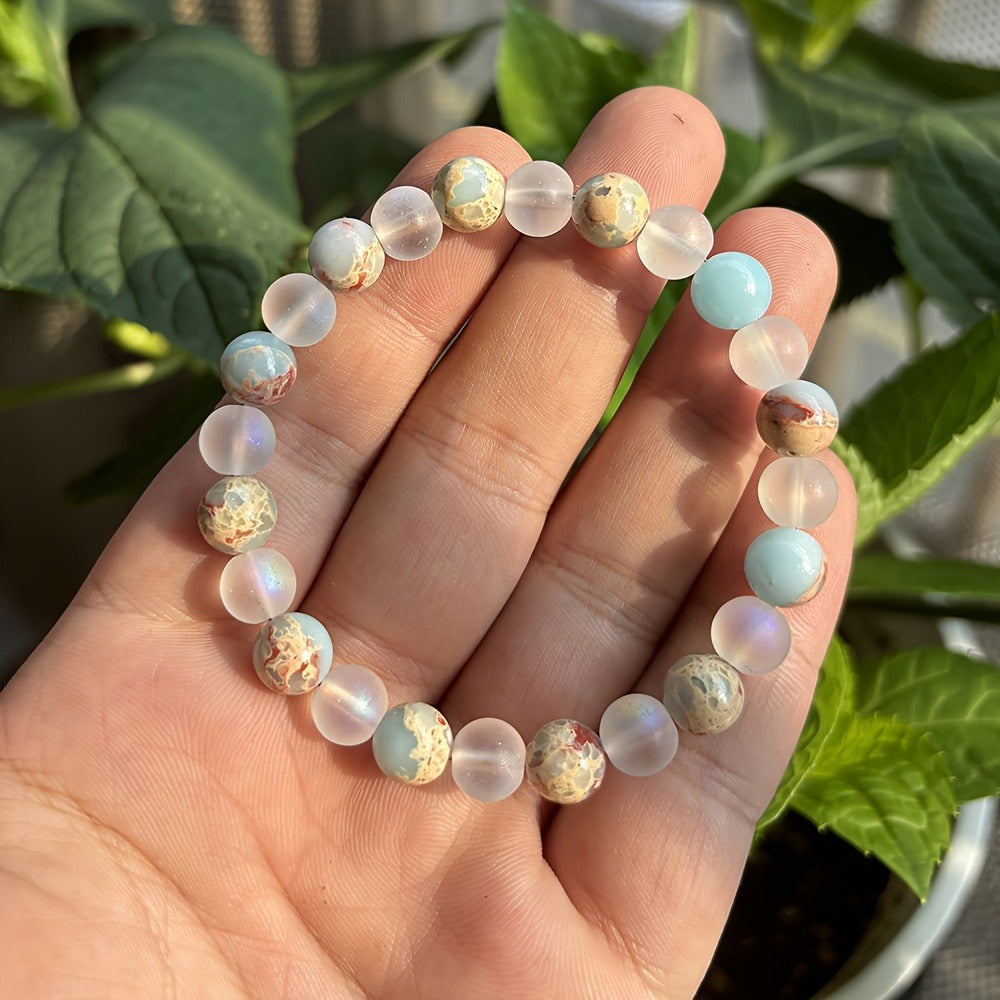 Hand wearing a beaded bracelet with a natural background