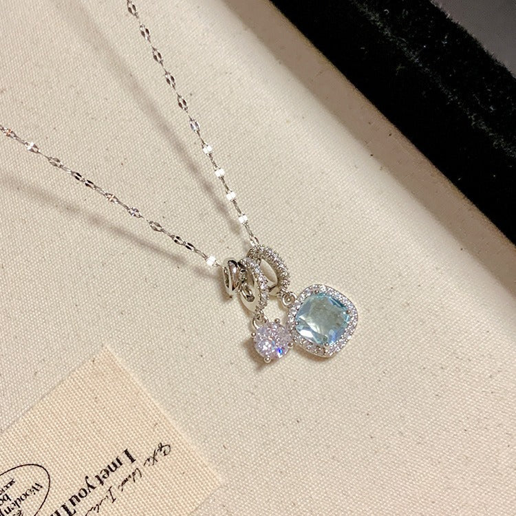 Necklace with a blue gemstone pendant on a beige surface