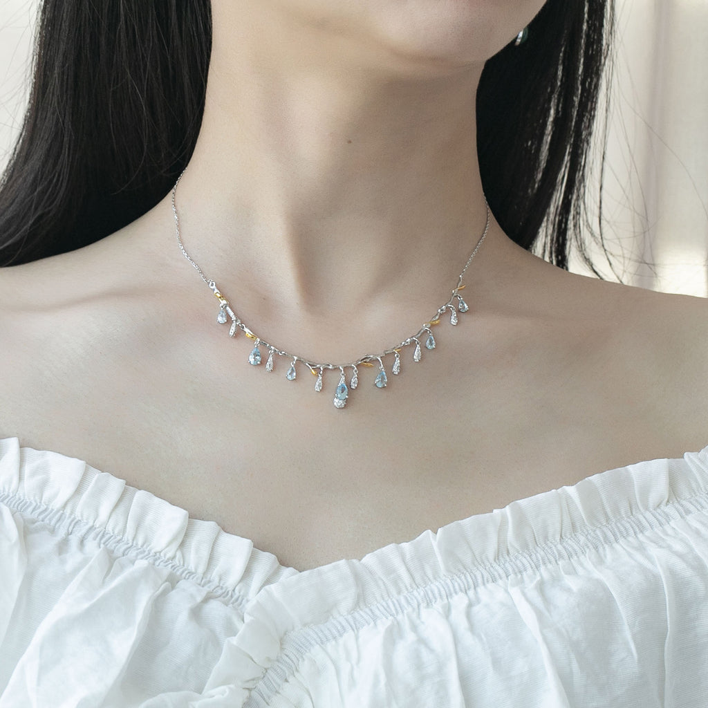 Necklace with small, colorful beads worn by a person against a neutral background