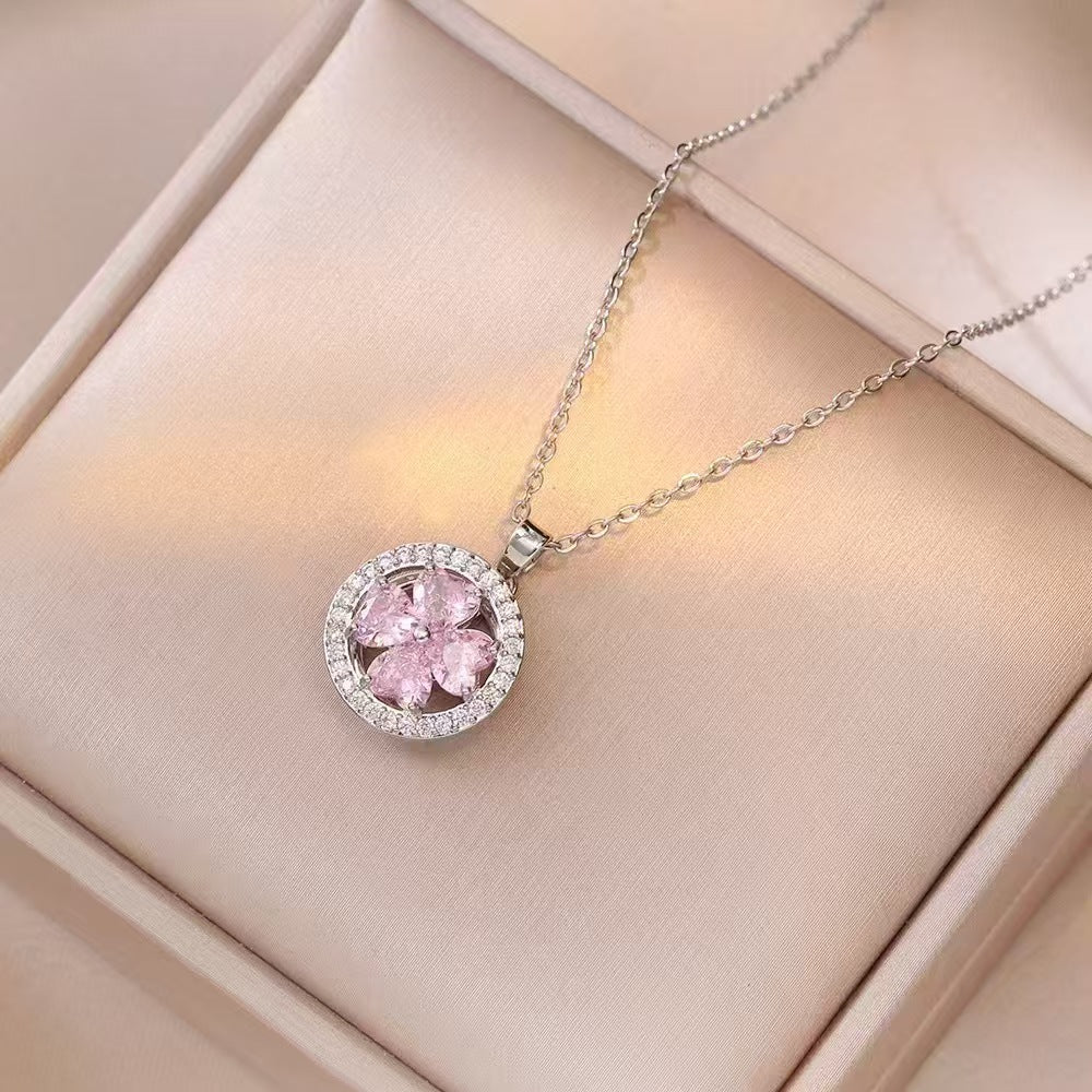 Pink gemstone necklace with silver chain on a beige box