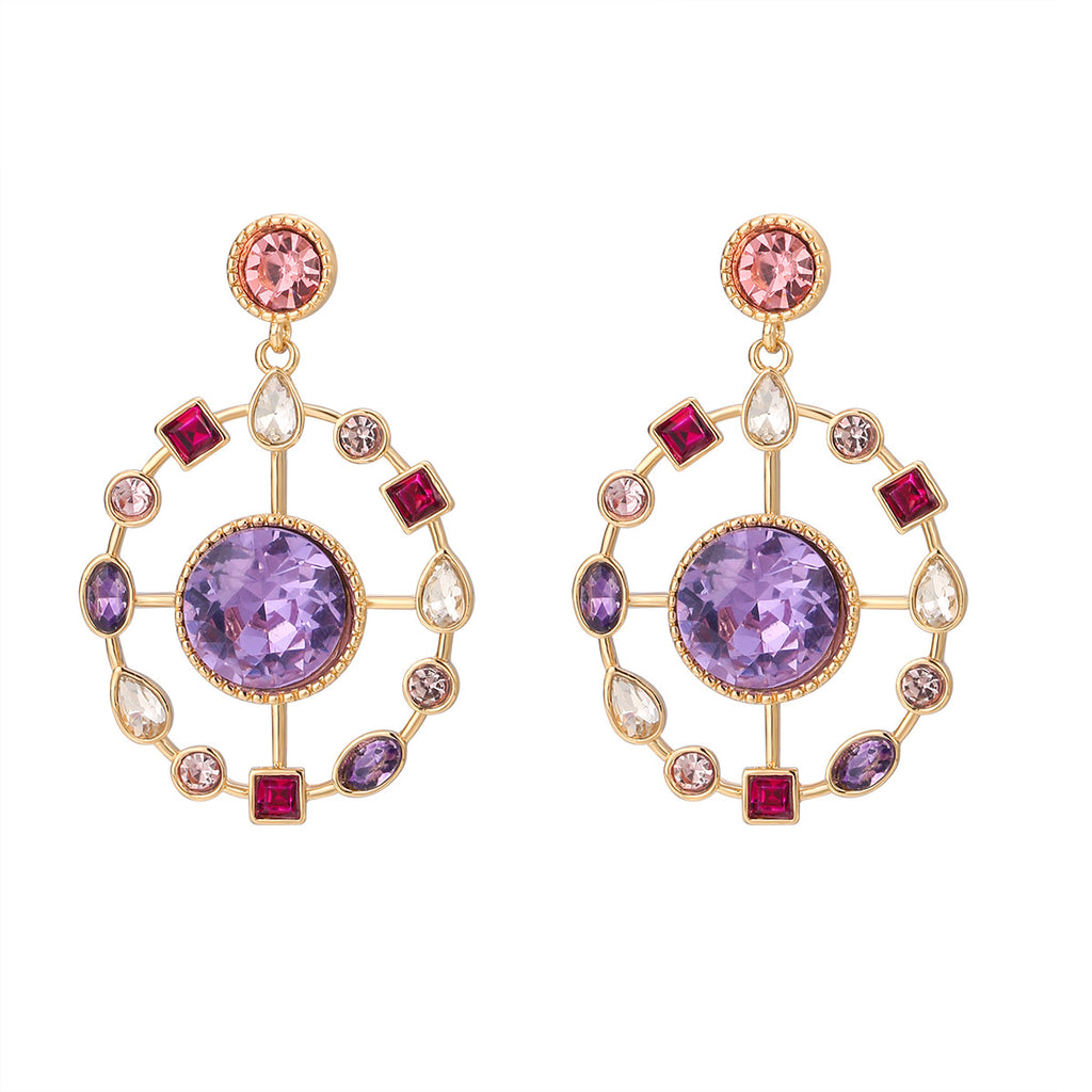 Pair of ornate earrings with purple gemstones and gold accents on a white background