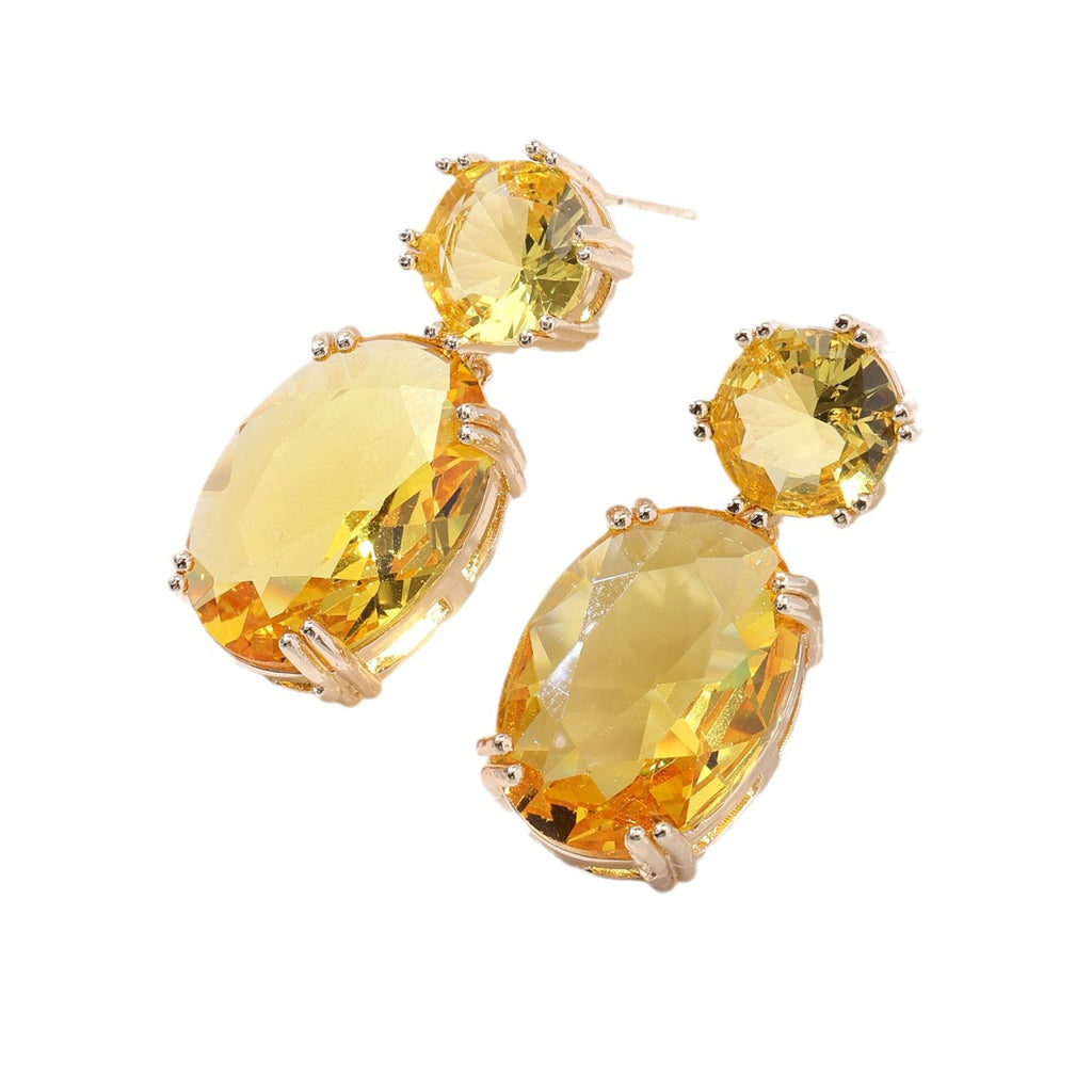 Pair of yellow gemstone earrings on a white background