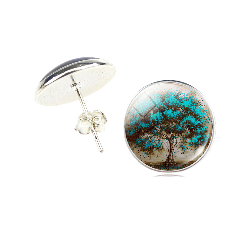 Round earrings with tree design on a white background