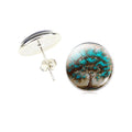 Round earrings with tree design on a white background