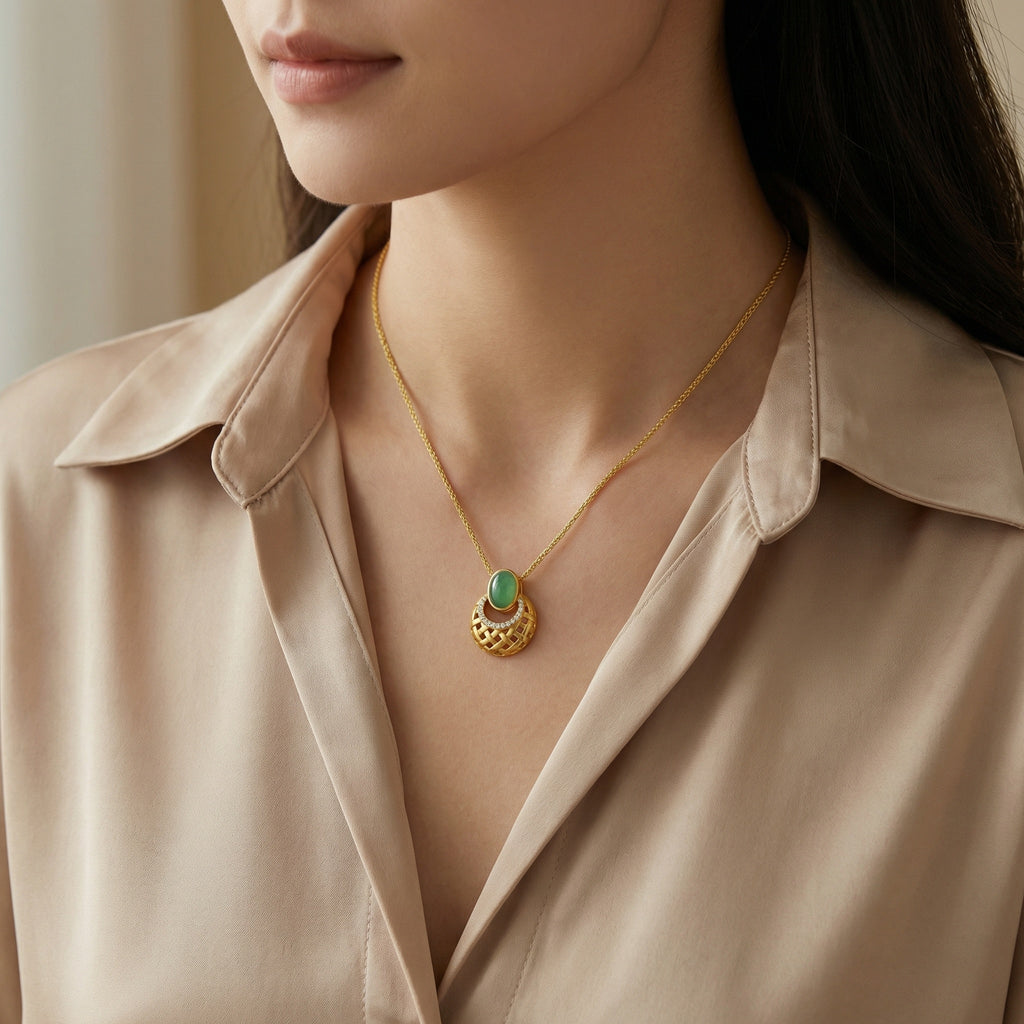 Woman wearing a gold necklace with a green pendant