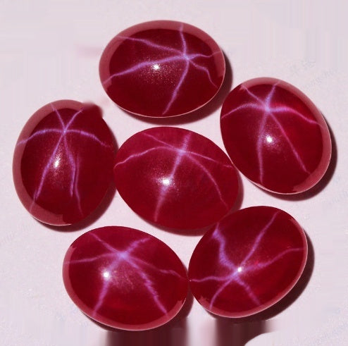 Red stones with white star-like patterns on a white background