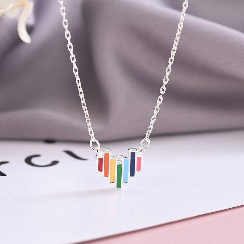 Necklace with colorful pendant on a soft fabric background
