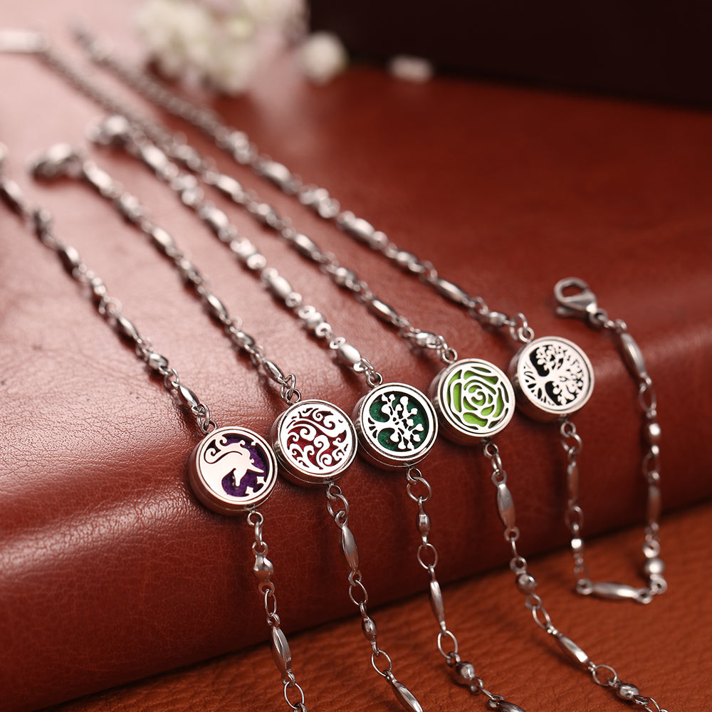 Silver necklaces with various pendants on a brown surface