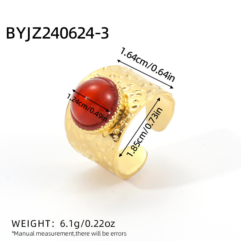 Gold ring with a red gemstone and measurements on a white background