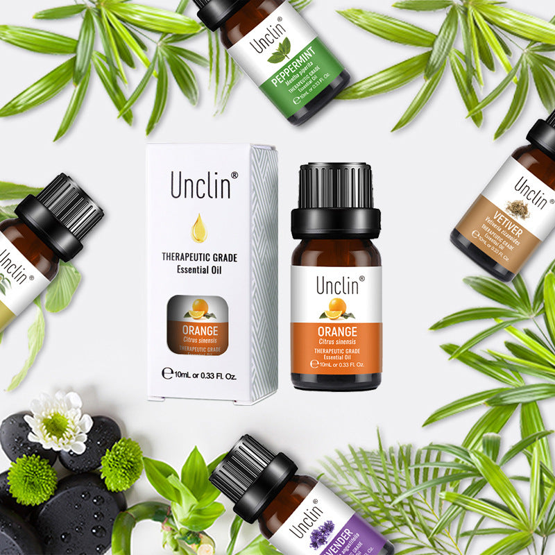 Collection of Unclin essential oil bottles and packaging on a white background with green leaves.