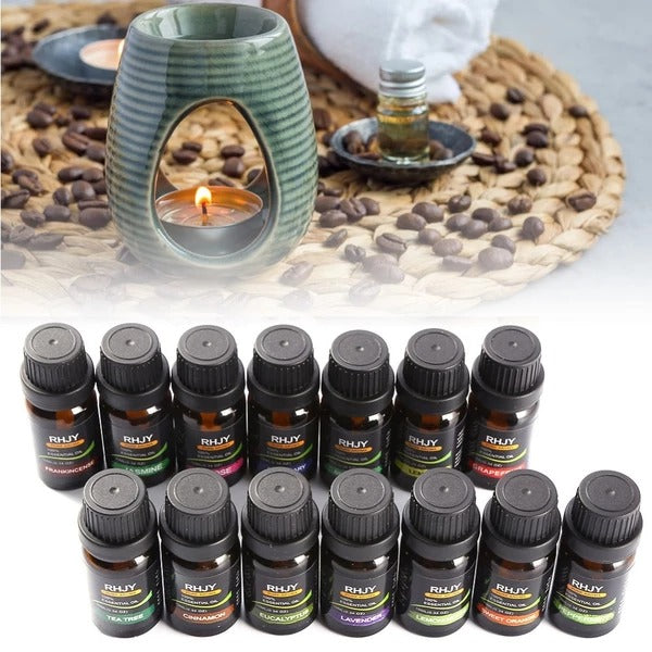 Collection of RILY essential oil bottles with a ceramic diffuser and candles on a textured surface.