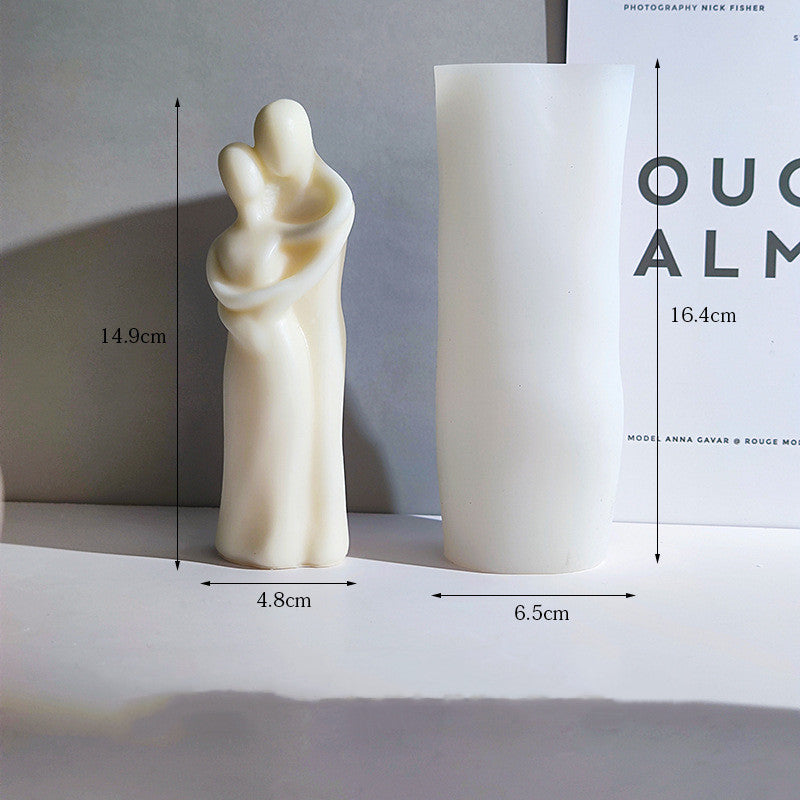 White sculpture of a woman holding a child with dimensions displayed on a gray background