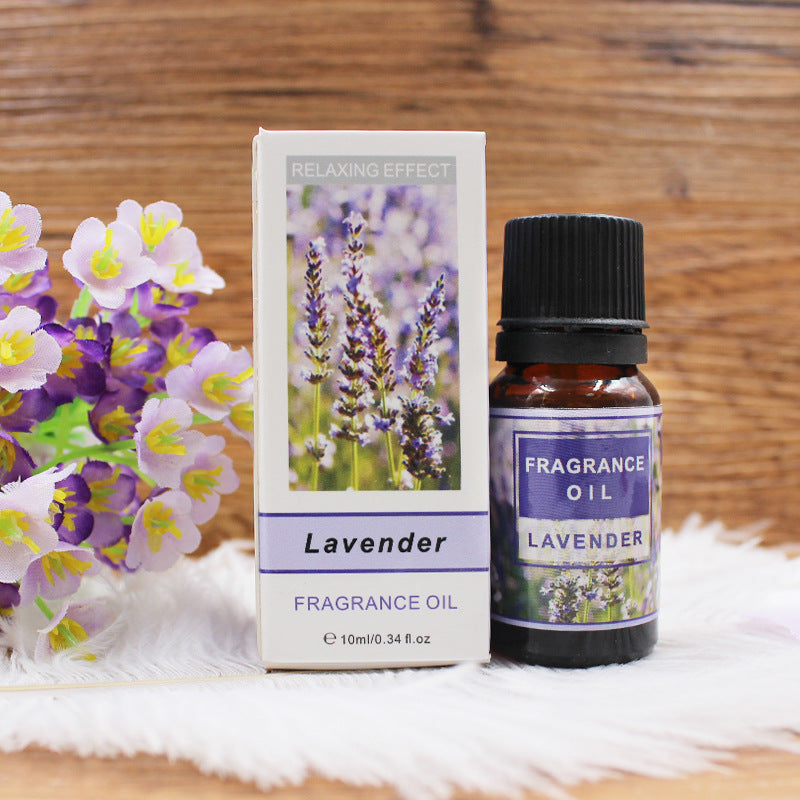 Fragrance oil bottle and packaging with lavender design on a wooden background