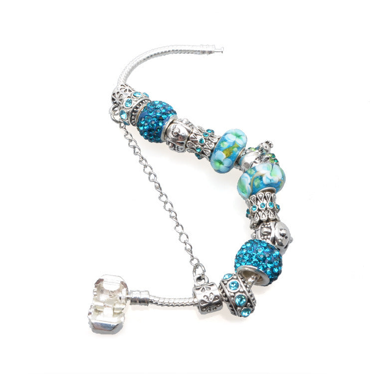 Bracelet with blue and silver beads on a white background