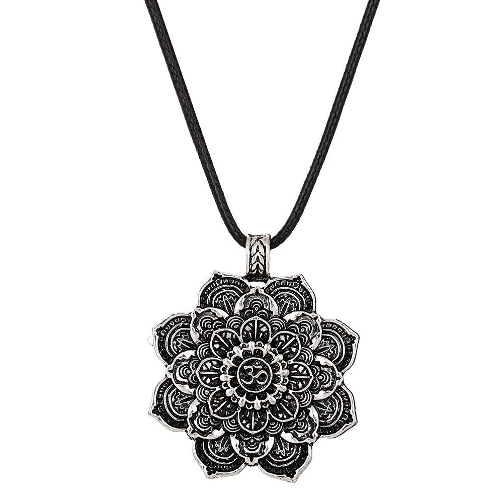 Silver mandala pendant on a black cord against a white background