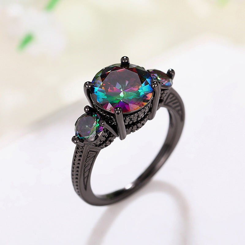 Ring with a multicolored gemstone on a white background