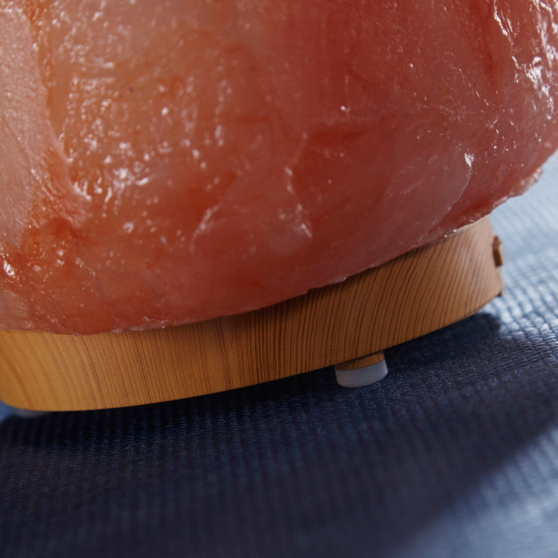 Close-up of a pinkish-red stone on a blue surface