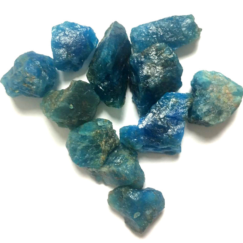 Blue raw gemstones on a white background
