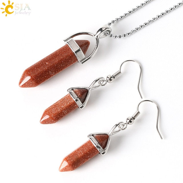 Jewelry set with red stone pendants and silver hooks on a white background