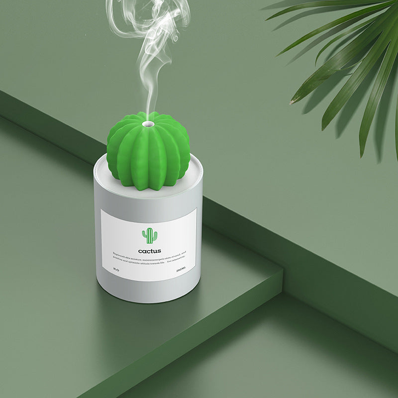 Green cactus-shaped diffuser on a green surface with a minimal background
