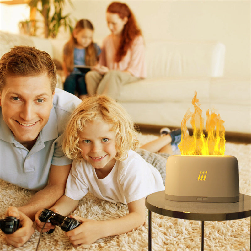 Man and child lying on the floor with a small table featuring a fire pit toy in a living room setting.