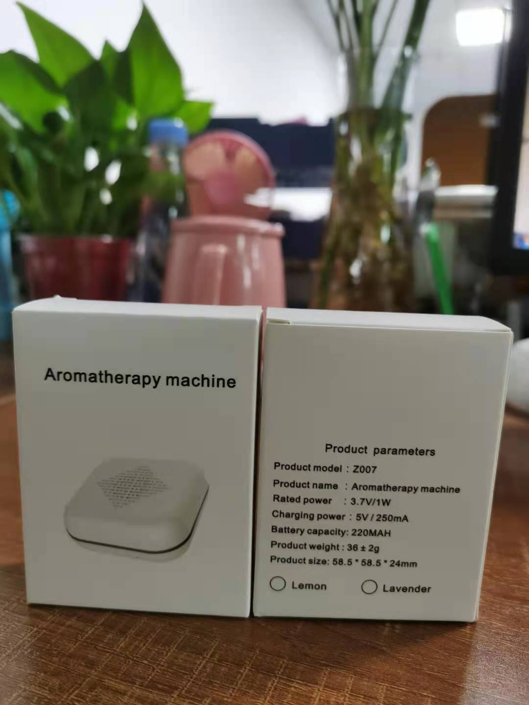Box of an aromatherapy machine with product details on a wooden surface.