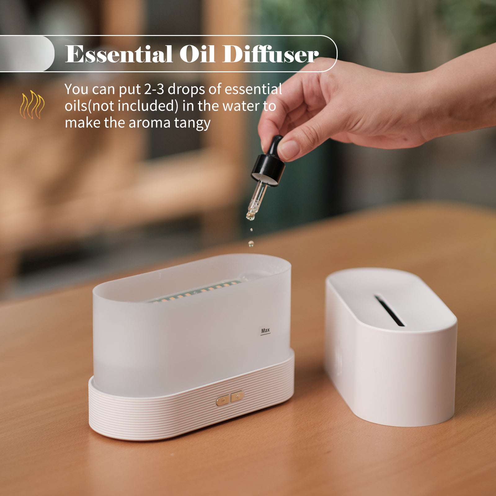 Essential oil diffuser with a hand adding drops of essential oil on a wooden surface.