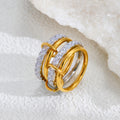 Gold and diamond ring on a textured white surface