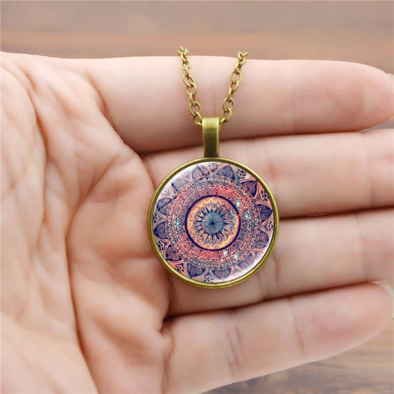 Necklace with a mandala pendant held in a hand