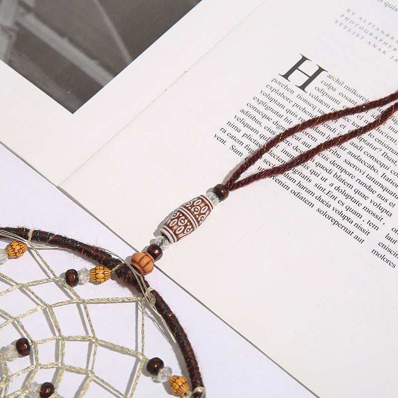 Dreamcatcher with beads on a book page