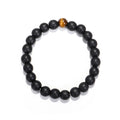 Black beaded bracelet with a single brown bead on a white background