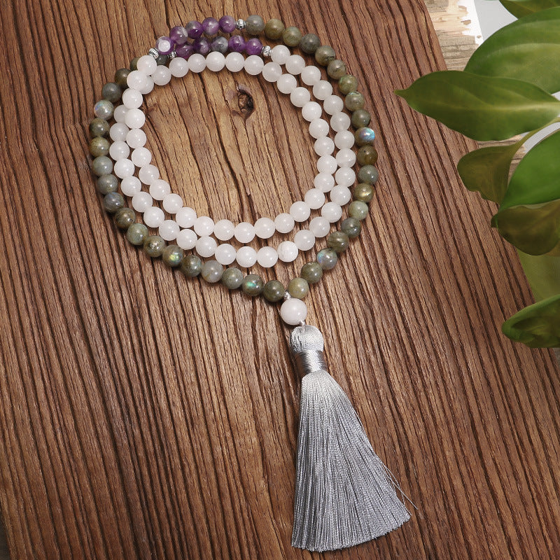 Beaded necklace with a tassel on a wooden surface