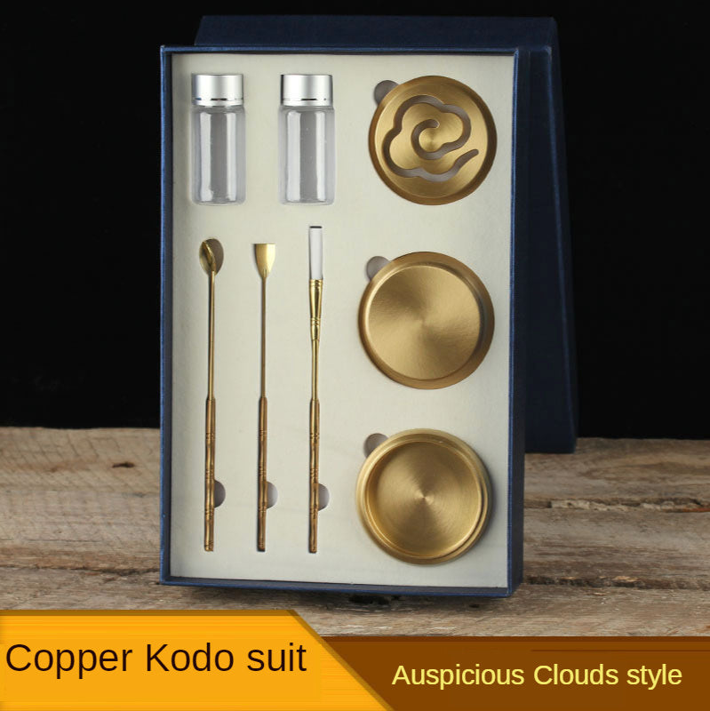 Copper Kodo suit with tea-making tools in a box on a wooden surface