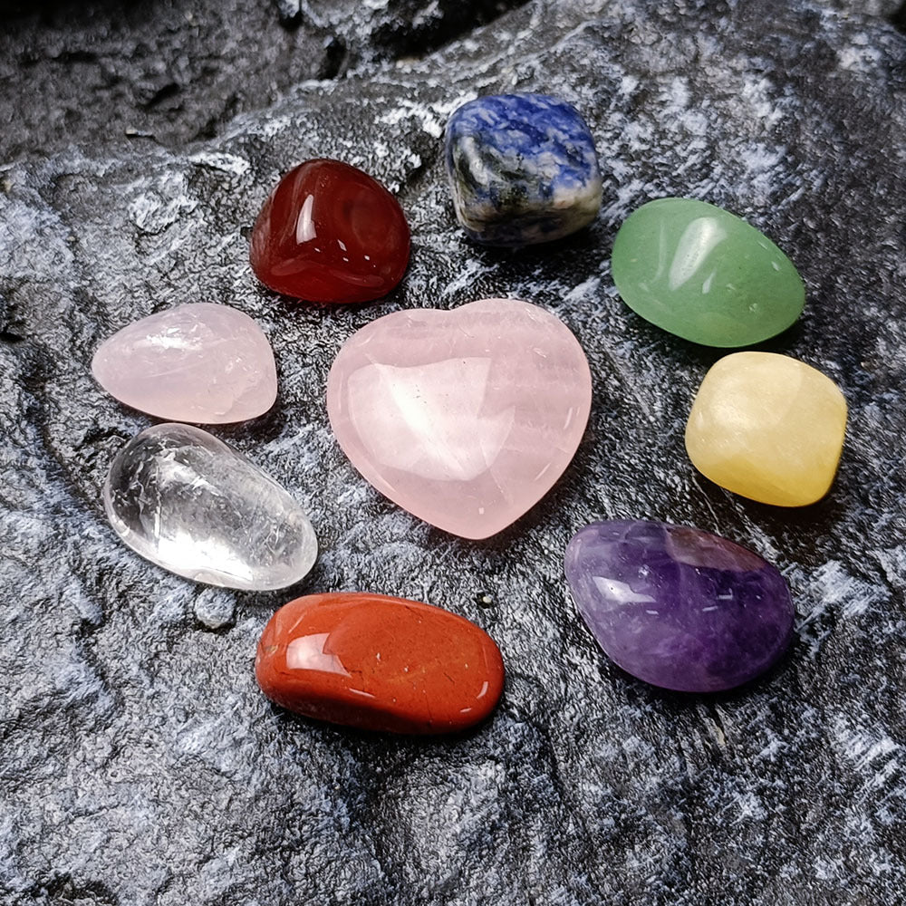 Collection of colorful crystals on a dark stone surface