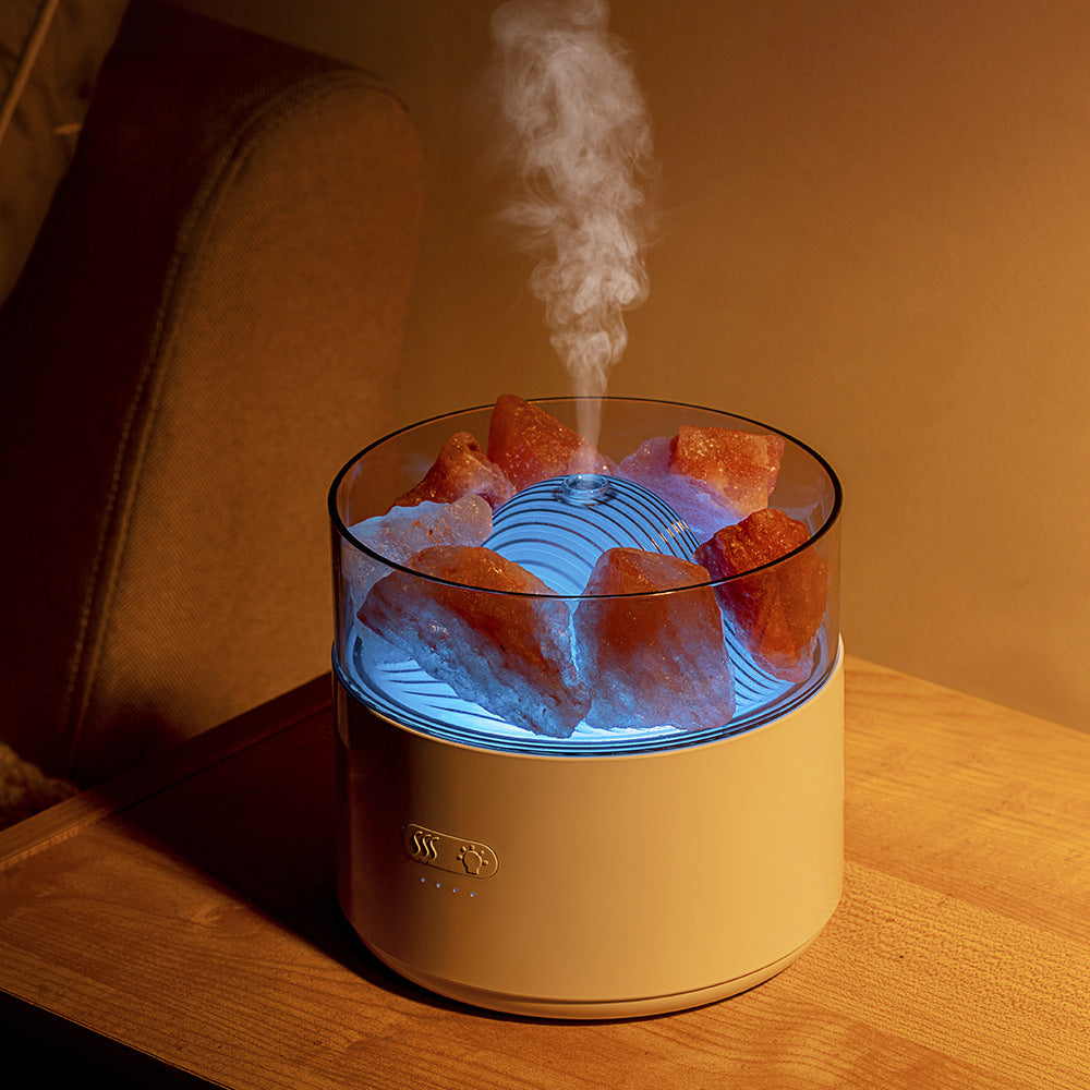Humidifier with ice cubes and steam on a wooden surface