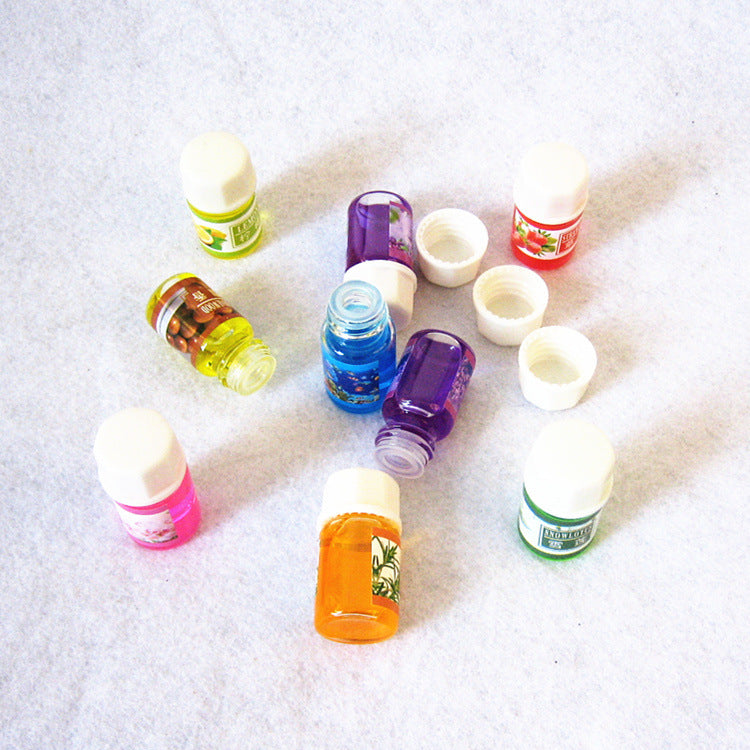 Assorted small bottles on a textured white surface