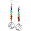 Pair of chakra beaded earrings with Om symbol on a white background