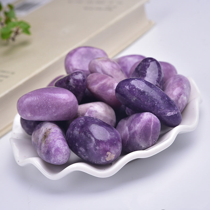 Purple stones on a white dish with a light background