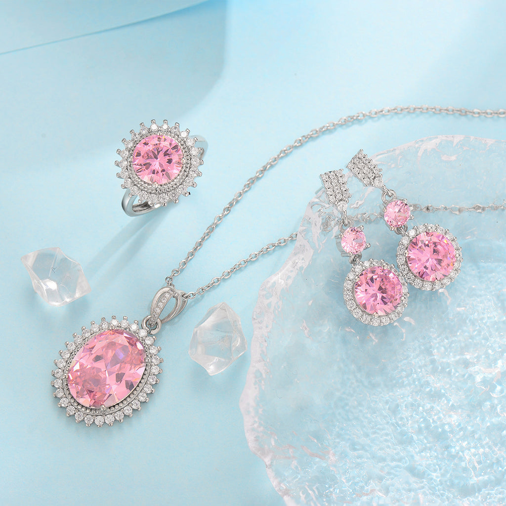 Jewelry set with pink gemstones on a light blue background