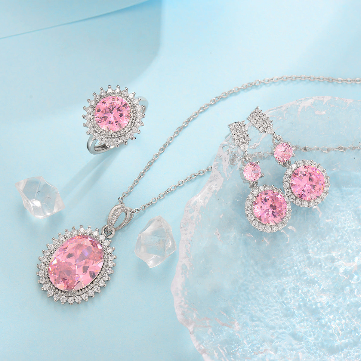 Jewelry set with pink gemstones on a light blue background