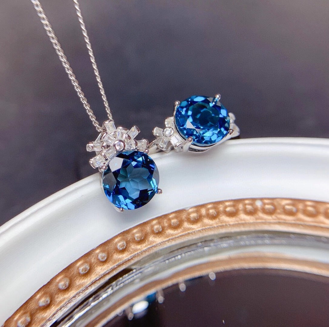 Jewelry set with blue gemstones on a white surface