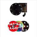 Turntable with three vinyl records featuring different album covers on a white background