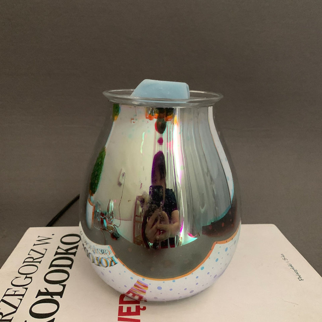 Glass container with colorful reflections on a surface with text