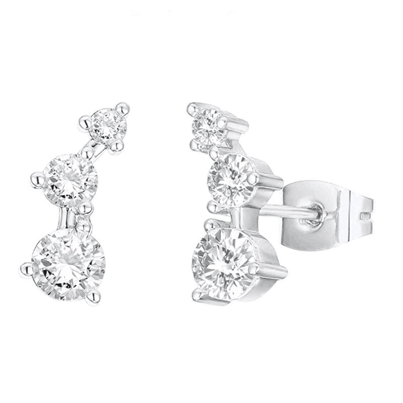 Silver earrings with clear gemstones on a white background