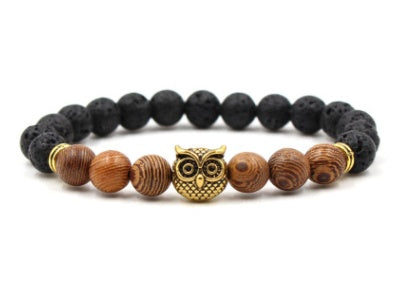 Bracelet with black and brown beads featuring an owl charm on a white background
